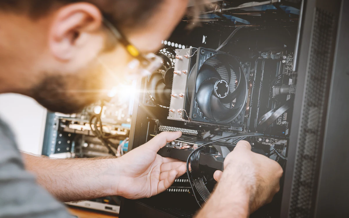 A technician installing a graphics card inside a computer